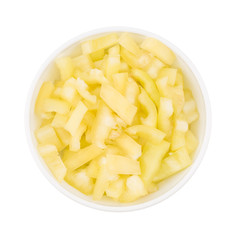 yellow sliced pepper in a white bowl. isolated on white backgrou