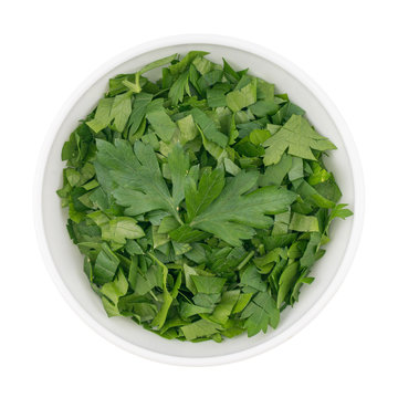 bowl of chopped parsley leaves isolated on white background