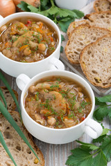 soup with cabbage and mushrooms in white bowls