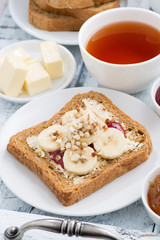 toast with peanut butter and banana, fresh black tea, closeup