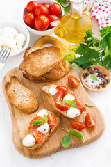 toasts with mozzarella, basil and cherry tomatoes 