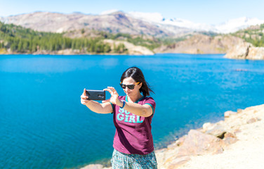 Woman take photo on lake in Yosemite National Park