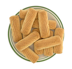 Vanilla cookie bars on a green striped plate top view isolated on a white background.