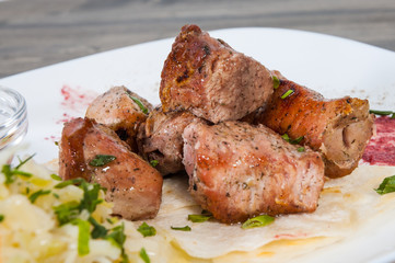 Shashlik. pieces of grilled meat with salad on a plate