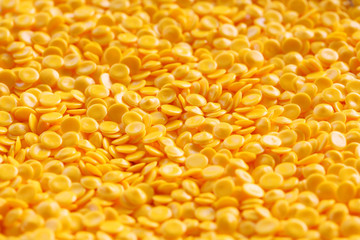 yellow plastic pellets as background.