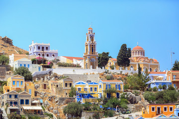 Church and colorful houses in the small town Symi, Greece