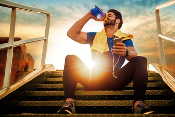 Young athlete man drinking protein cocktail