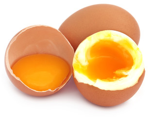 Broken eggs over white background