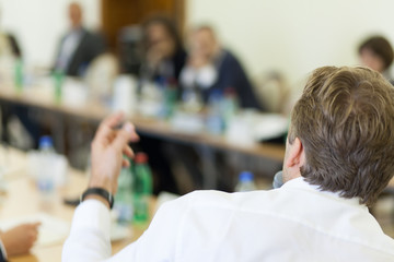 gesturing hands at business meeting