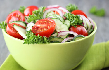 the fresh vegetable salad in a green bowl