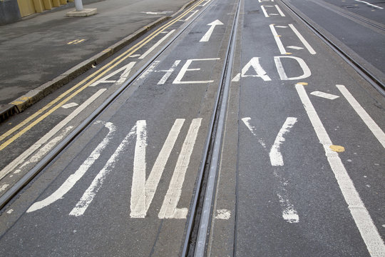Tram Tracks and Arrow Sign on Street in Nottingham, England