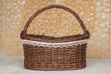 Fototapeta na wymiar Empty wicker brown basket for fruit and bread in cousy backgrou