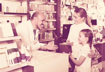 Male pharmacist at the counter in pharmacy .