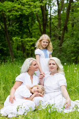 Happy family resting on the nature in the summer