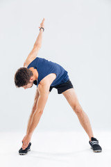 Fototapeta na wymiar Portrait of sportsman standing and doing warm up exercises