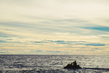 Silhouette jet ski on the sea in sunset