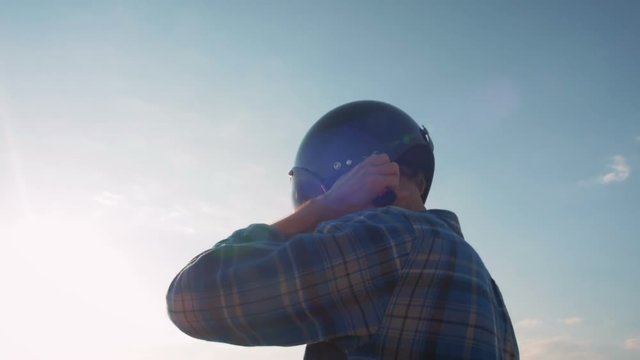 Motorcyclist putting on his helmet, dolly
