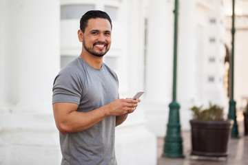 Handsome man using a smartphone outdoors