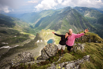 Hiker couple portraiture on top of the Carpathian mountain.