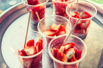 strawberry in plastic cups at street market