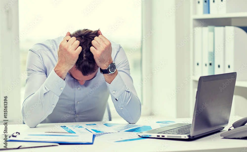 Wall mural stressed businessman with papers in office