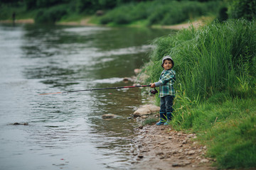 boy fishing on the coast of river
