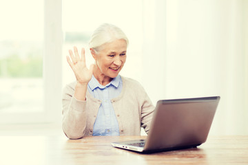 senior woman with laptop having video chat at home