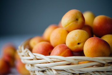 Fresh apricots in the basket on a table