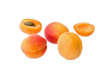 Ripe apricots with slices isolated on white background