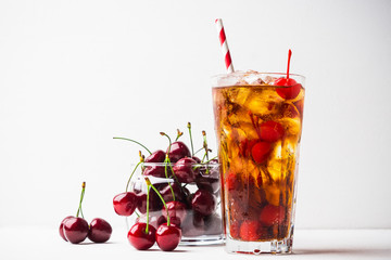 Refreshing cold cherry cola on the wooden background