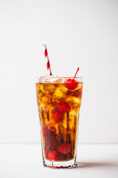 Refreshing cold cherry cola on the wooden background