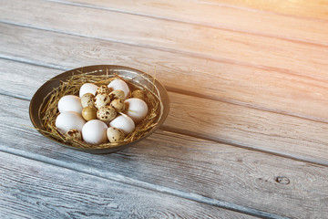 Chicken and quail eggs. Uncooked eggs in a bowl. Protein and cholesterol. Ingredients for tasty omelet.