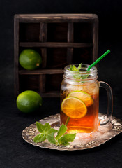 Cold tea with lime and mint in a glass jar