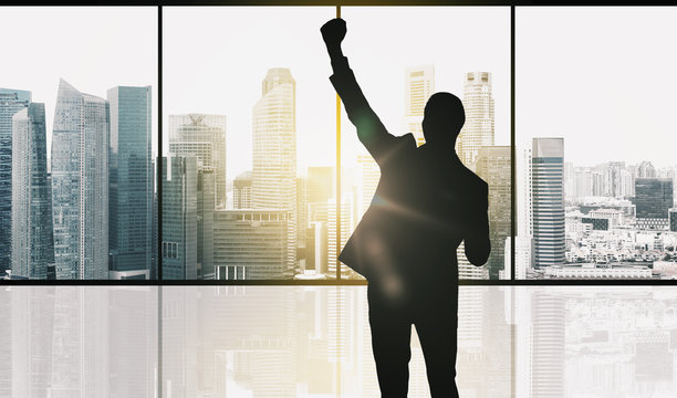 Silhouette Of Business Man Over Office Background