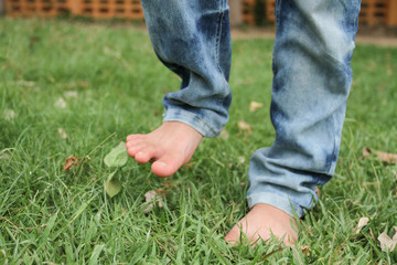 Foot child standing on the lawn