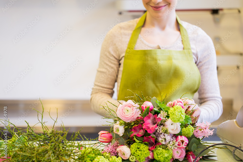 Wall mural close up of woman making bunch at flower shop