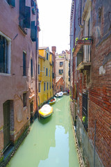 Fototapeta na wymiar Small and narrow canals in Venice