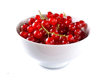 Fresh red currant into a bowl isolated on white.