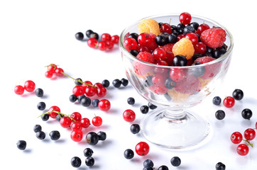 Fresh berries in a glass bowl on a white background.