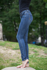 Back view of a long women legs posing with jeans