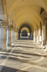 Fototapeta na wymiar The colonnade under Doge s Palace - Piazza Ducale San Marco