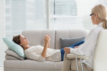 Woman talking to therapist while lying on sofa