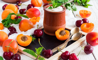 Fresh jogurt with organic ripe apricots and cherries