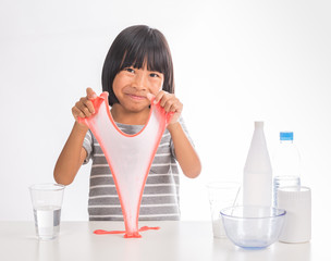 cute little asian girl making science experiment of slime on iso
