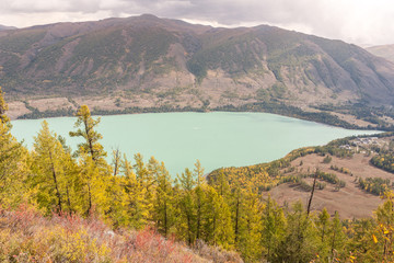 kanas lake in autumn with crystal blue water. Green trees. The natural beauty of the paradise. Kanas Nature Reserve. Xinjiang Province, China.