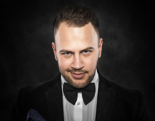 Fototapeta premium Young handsome man in black suit.