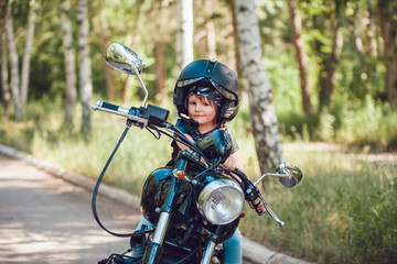 Fototapeta na wymiar Little girl on a motorcycle.