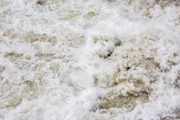 Wild rapids and large volume of water flowing down a river.