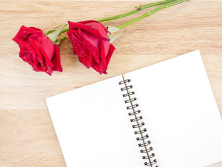 Two red rose flower and blank notebook 1