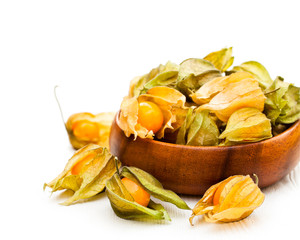 ripe  physalis in wooden bowl on white background